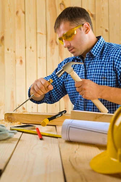 Carpenter works with the chisel