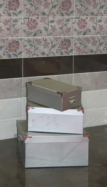 A pile of decorative boxes on the floor