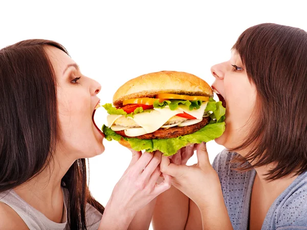 Women eating hamburger.
