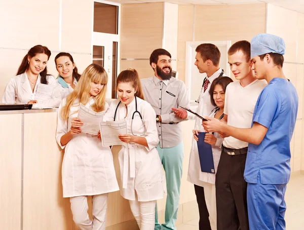 Group doctors at reception in hospital.