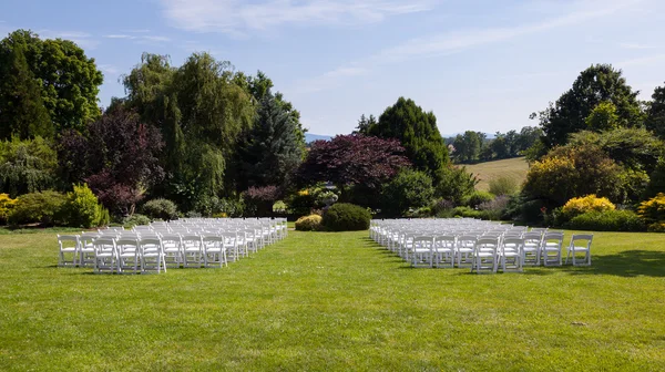 Rows of wooden chairs set up for wedding