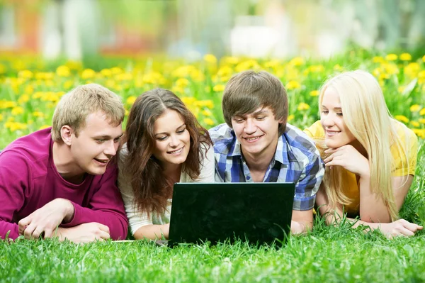 Young students group with computer outdoors