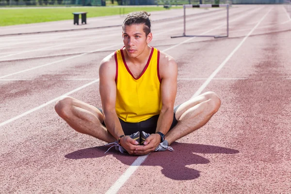 Track and Field Athlete Stretching — Stock Photo #12126816