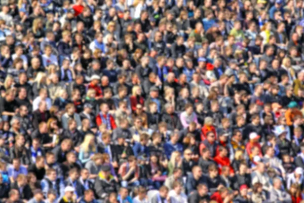 Blurred crowd of spectators on a stadium tribune