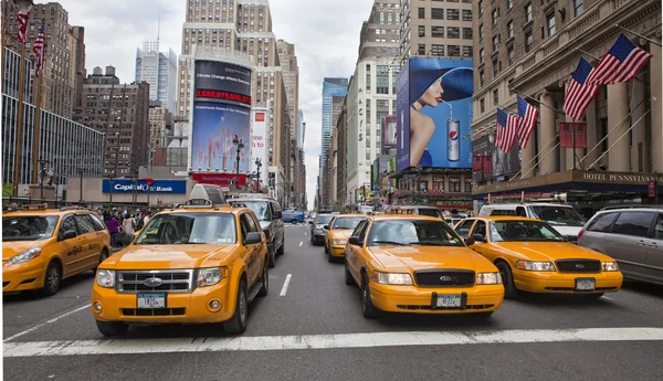 NEW YORK - MAY 28: Group of yellow taxi cabs rush tourists aroun