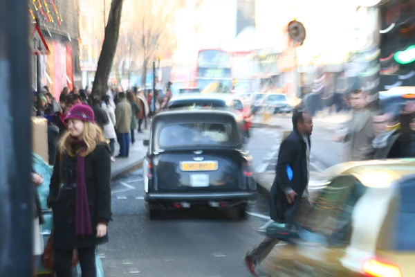 Blurred image of typical street life in London