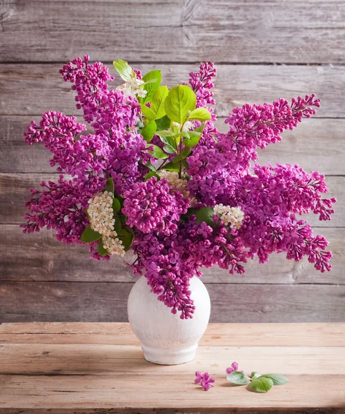 Still life with a blooming branch of lilac