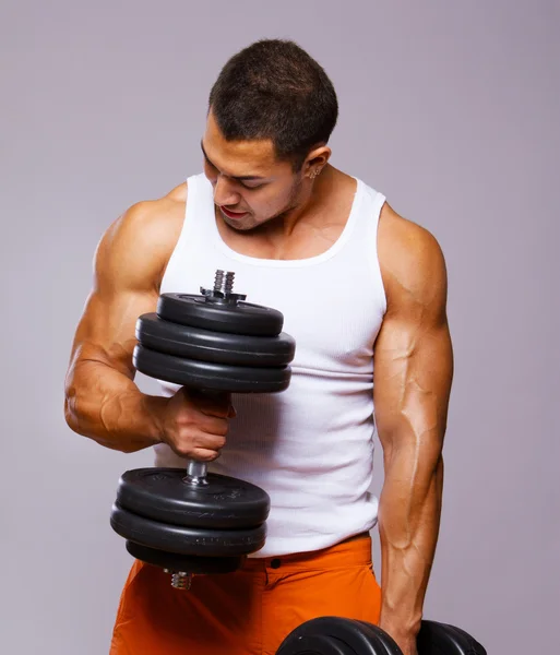 Portrait of young man lifting weights
