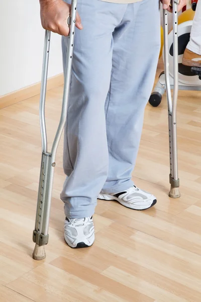 Woman Standing With Crutches