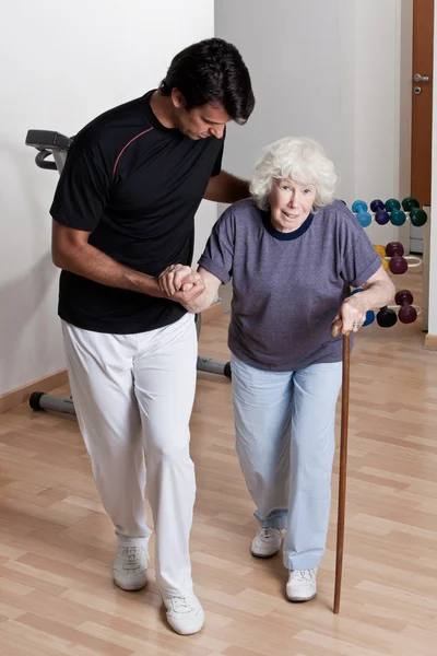 Therapist helping Patient To Walk