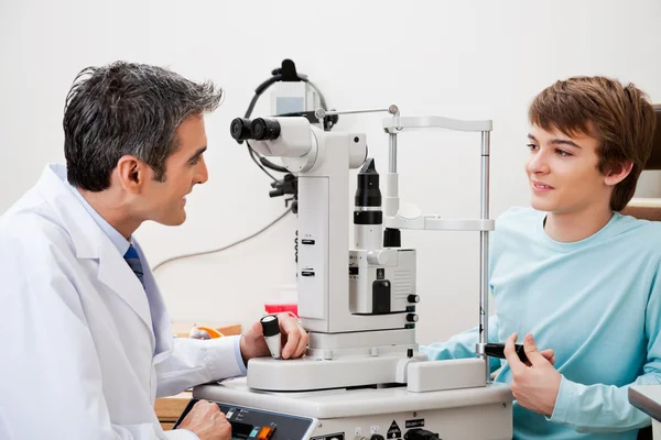Boy Consulting Doctor After Visual Field Test