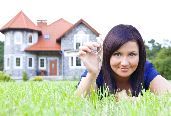 Woman holding keys to house
