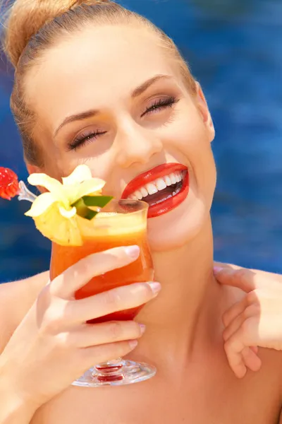 Glamorous woman enjoying a tropical cocktail