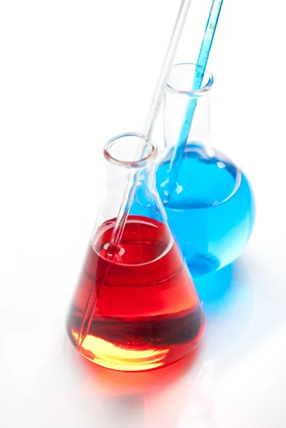 Two glass flasks with a colored liquid