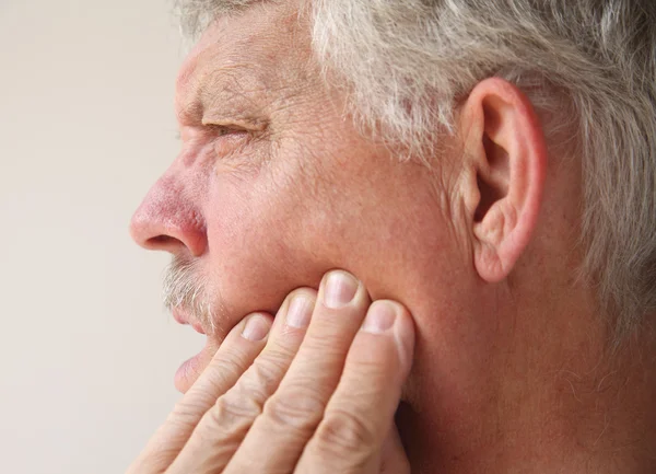 Man with tooth or jaw pain