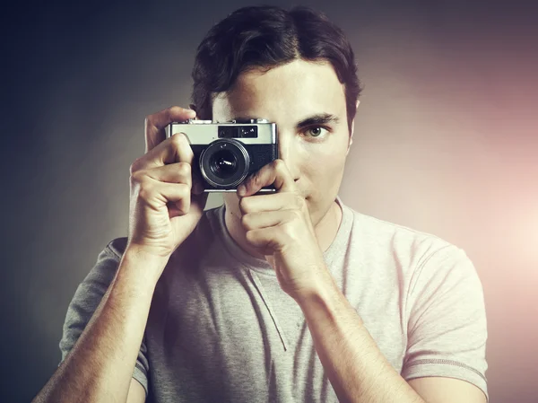 Portrait of young male photographer with a camera