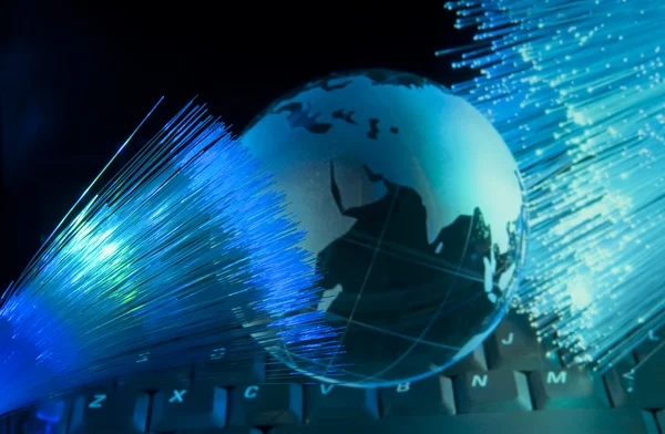 Computer data concept with earth globe against fiber optic background