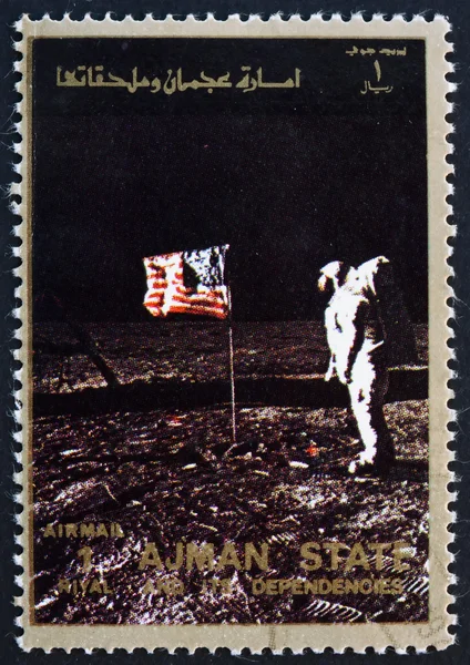 Postage stamp Ajman 1973 Aldrin Salutes U.S. Flag on the Lunar S