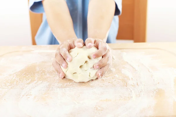 Child kneading dough