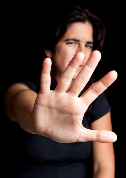 Frightened woman with her hand extended