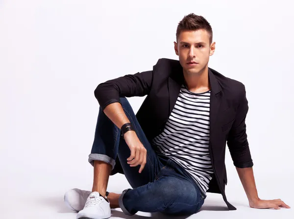 Young fashion man sitting relaxed