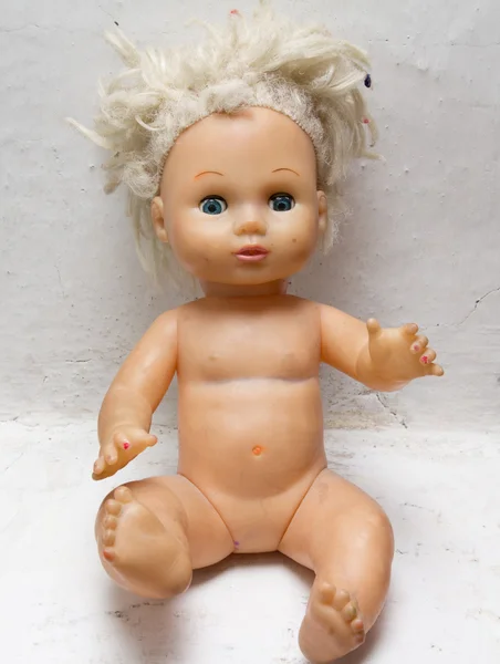 Old doll on a white background