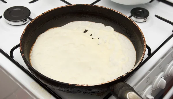 Frying a pancake cooking in a pan