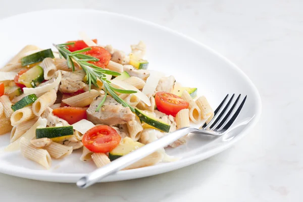 Pasta penne with turkey meat and vegetables