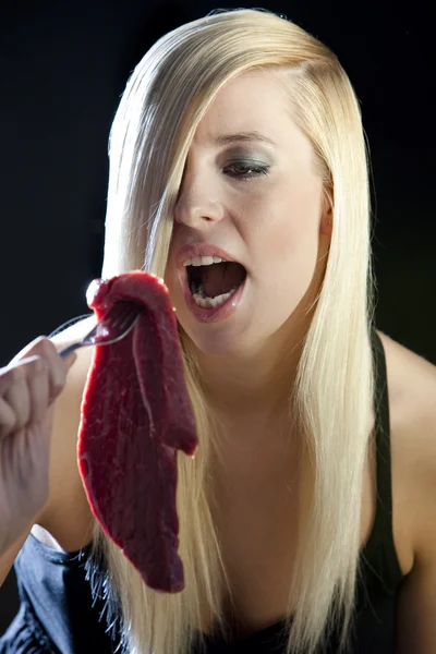 Portrait of woman with raw meat