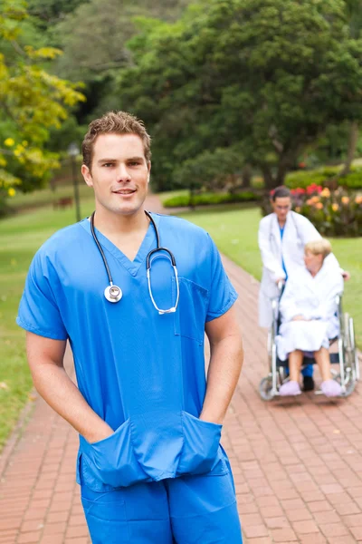 Friendly young male doctor portrait outdoors