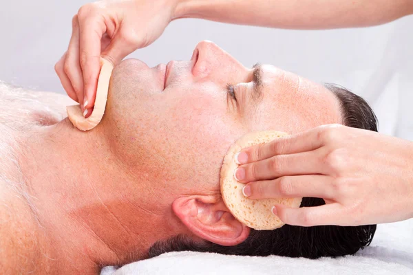 Middle age man receiving facial massage