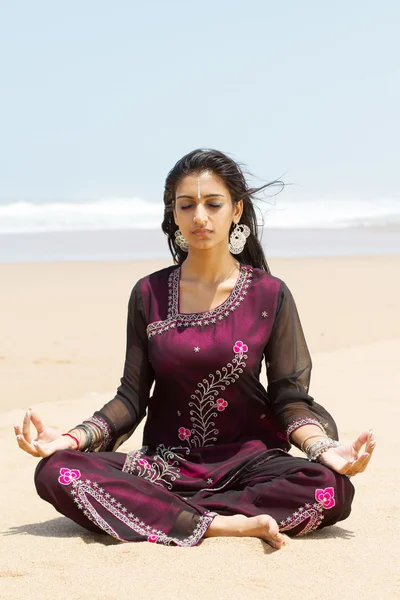 Indian woman in traditional clothing on beach