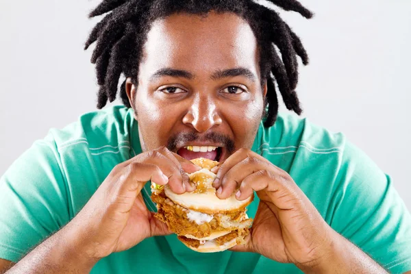 African american man eating hamburger