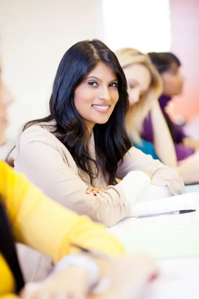 Attractive female college students in classroom — Stock Photo