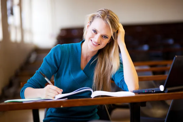 Happy college student in classroom