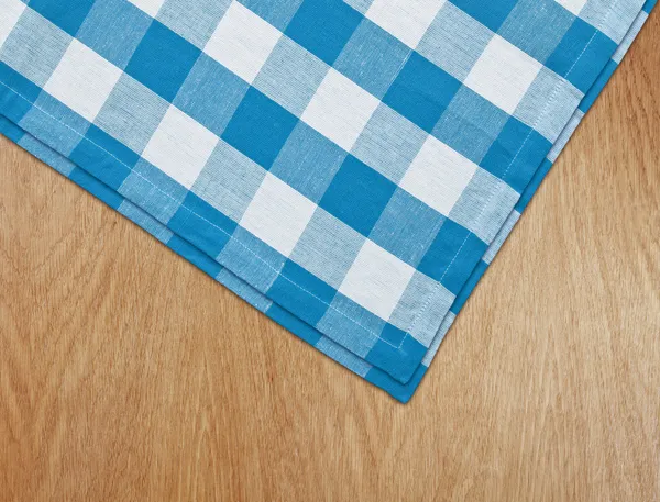 Wooden kitchen table with blue gingham tablecloth