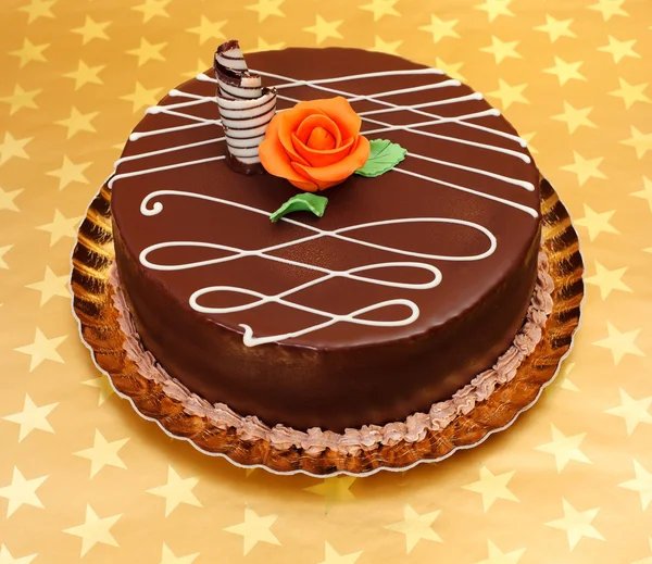 Chocolate cake on golden stars background