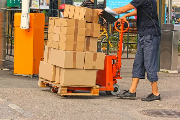 A fork pallet truck stacker with stack of boxes