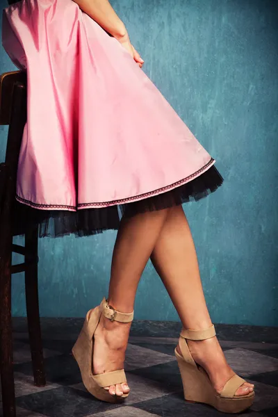 Pink skirt and wedge high heel shoes