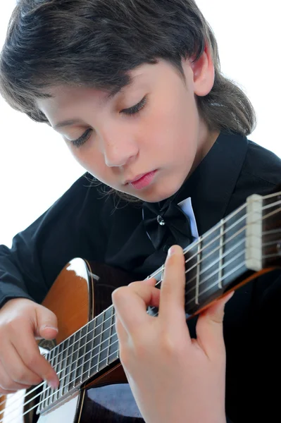 Little boy musician playing guitar
