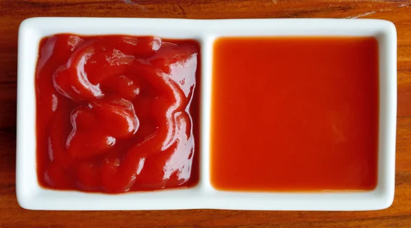 Chilli sauce and tomato sauce in white dish