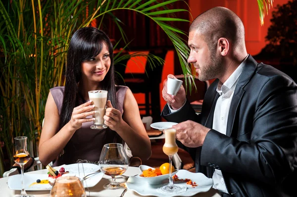 Beautiful couple in love drinking coffee at restaurant
