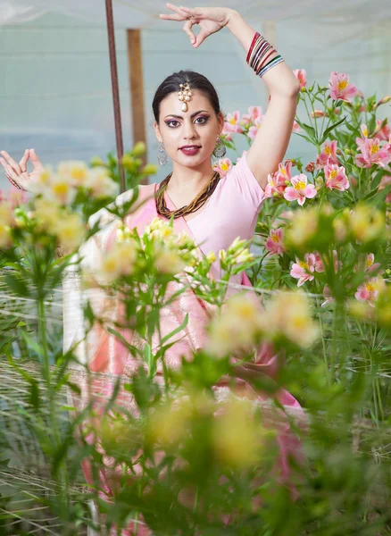 Beautiful indian girl in the indian national dress on greenhouse