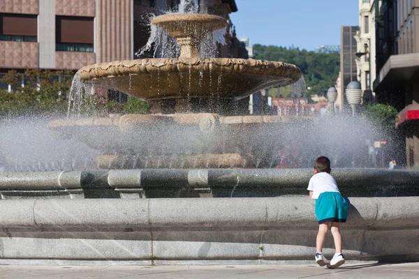 Children cooling off in the fountain in summer