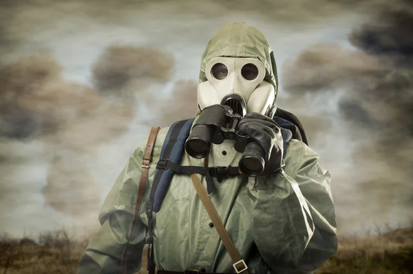Man in gas mask with binocular