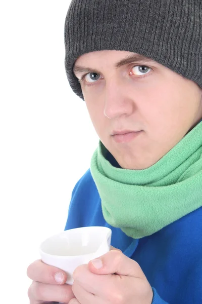Young man in blue sweater and green scarf with cup