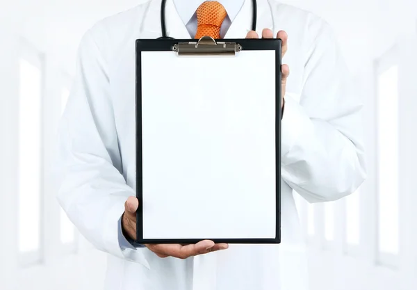 Doctor holding blank clipboard