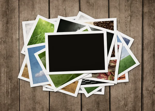 Stack of photos at wooden background