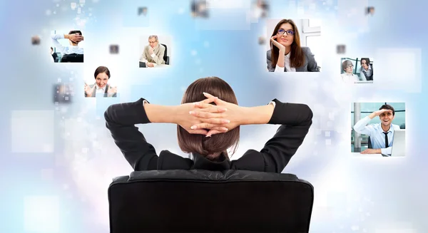 Portrait of businesswoman from behind communicating with her team