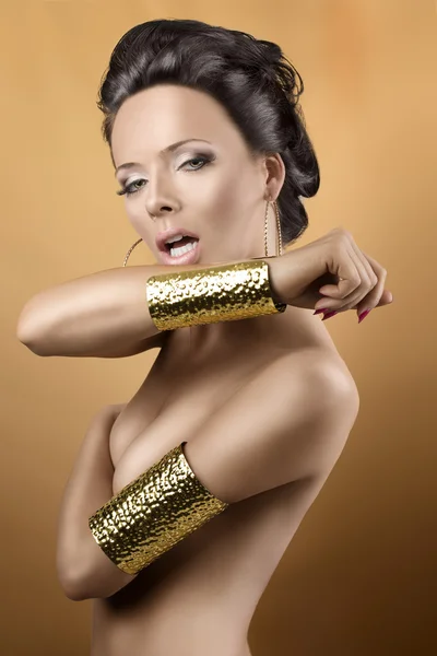 Sexy brunette with two golden bracelets, with open mouth